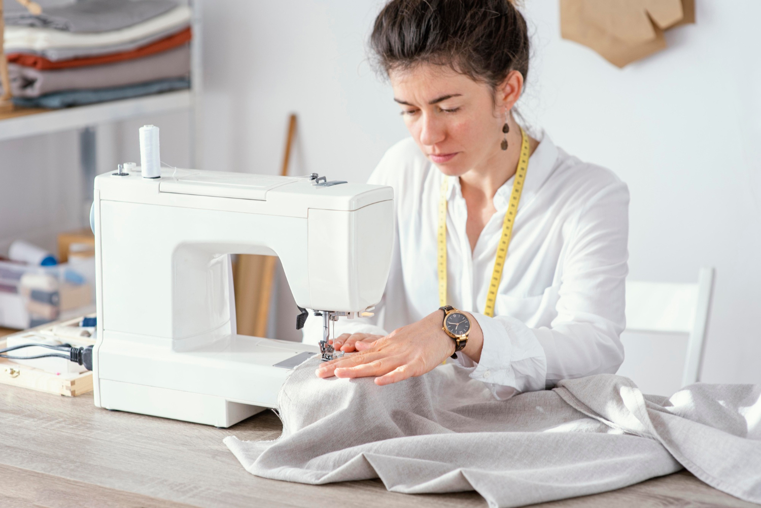 front-view-female-tailor-working-with-sewing-machine